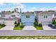 Charming two-story blue home featuring a one-car garage, and lush landscaping at 15133 Summer Harvest St, Winter Garden, FL 34787
