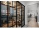 Bright hallway featuring glass-walled office, and an open view to the modern kitchen and living spaces at 15133 Summer Harvest St, Winter Garden, FL 34787