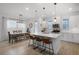 Bright eat-in kitchen with white cabinetry, quartz countertops, pendant lighting, and stainless steel appliances at 15133 Summer Harvest St, Winter Garden, FL 34787