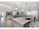 Open kitchen featuring a large island, stainless steel appliances, and open view to the living room at 15133 Summer Harvest St, Winter Garden, FL 34787