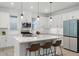Bright kitchen with island, pendant lighting, stainless appliances, and sleek white cabinetry at 15133 Summer Harvest St, Winter Garden, FL 34787