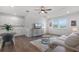Well-lit living room featuring light hardwood floors and a dining nook at 15133 Summer Harvest St, Winter Garden, FL 34787