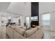 Open-concept living room with fireplace, leading into a modern kitchen with white cabinetry at 15133 Summer Harvest St, Winter Garden, FL 34787