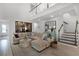 Spacious living room with staircase, stylish decor, and a view of the second-story landing at 15133 Summer Harvest St, Winter Garden, FL 34787