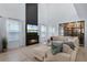 Spacious living room featuring a fireplace, large windows, a comfortable sectional, and a decorative glass wall at 15133 Summer Harvest St, Winter Garden, FL 34787