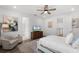 Airy main bedroom with a ceiling fan, painting, and ensuite bathroom with a patterned area rug at 15133 Summer Harvest St, Winter Garden, FL 34787
