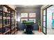 Bright home office with wooden desk, airplane art, wood accent wall, shelving, and glass door at 15133 Summer Harvest St, Winter Garden, FL 34787