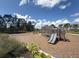 Community playground with a slide and play structure surrounded by trees at 15133 Summer Harvest St, Winter Garden, FL 34787