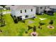 Aerial view of a spacious backyard with lush grass, young trees, and sunshades offers space for recreation at 1588 Sky Lakes Dr, St Cloud, FL 34769