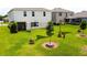 Spacious backyard with lush green grass, young trees, and stylish sunshades offers ample space for outdoor activities at 1588 Sky Lakes Dr, St Cloud, FL 34769