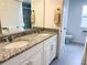 Bathroom featuring double vanity with granite countertops and modern fixtures at 1588 Sky Lakes Dr, St Cloud, FL 34769