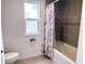 Clean bathroom with tile shower, bathtub, and stylish shower curtain at 1588 Sky Lakes Dr, St Cloud, FL 34769