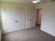 Bright bedroom features a closet, neutral walls, and plush carpeting for a cozy and inviting space at 1588 Sky Lakes Dr, St Cloud, FL 34769