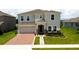 Charming two-story home features a brick driveway, two-car garage, and a well-manicured lawn at 1588 Sky Lakes Dr, St Cloud, FL 34769