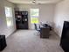 Bright office space with a dark wood desk, shelving unit, and comfortable seating at 1588 Sky Lakes Dr, St Cloud, FL 34769