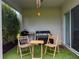 Covered patio with a grill, seating and artificial turf, creating a perfect space for outdoor dining and relaxation at 1588 Sky Lakes Dr, St Cloud, FL 34769