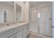 Elegant bathroom with a double vanity, granite countertops, and a glass-enclosed shower enhancing a spa-like experience at 172 S Zuni Rd, St Cloud, FL 34771
