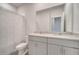 Bathroom featuring double vanity sinks, a large mirror, and a shower with modern fixtures at 172 S Zuni Rd, St Cloud, FL 34771