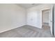 Neutral bedroom with gray carpet, closet and a view to the hallway at 172 S Zuni Rd, St Cloud, FL 34771
