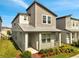 Charming two-story home featuring a modern design with neutral tones, well-maintained landscaping, and a welcoming front porch area at 172 S Zuni Rd, St Cloud, FL 34771