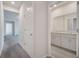 Hallway leading to a bathroom with double sinks and granite countertops; neutral color palette throughout, offering modern living at 172 S Zuni Rd, St Cloud, FL 34771