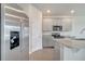 Modern kitchen featuring stainless steel appliances, gray cabinetry, and a spacious island for cooking and entertaining at 172 S Zuni Rd, St Cloud, FL 34771