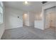 Spacious living area featuring plush carpeting and neutral paint, perfect for relaxation and gatherings, creating a cozy ambiance at 172 S Zuni Rd, St Cloud, FL 34771