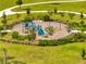 Aerial view of community playground with swings, slide, play structure, and bench seating at 172 S Zuni Rd, St Cloud, FL 34771
