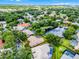 Aerial view highlighting a property with lush landscaping, a tile roof, and a serene pond nearby at 174 Promenade Cir, Lake Mary, FL 32746