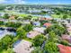 An aerial view of a neighborhood showing community amenities with pools, landscaping, and a golf course at 174 Promenade Cir, Lake Mary, FL 32746