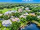 Beautiful aerial shot of a residential property with a screened pool, mature trees, and a tranquil pond nearby at 174 Promenade Cir, Lake Mary, FL 32746