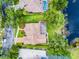 Aerial view showcasing the home's backyard, tiled roof, and proximity to a serene lake at 174 Promenade Cir, Lake Mary, FL 32746