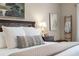 Bedroom with a decorative headboard, soft pillows, and warm lighting creates a comfortable and stylish space at 174 Promenade Cir, Lake Mary, FL 32746