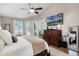 Bedroom with a large TV, French doors, and plenty of natural light, creating a relaxing retreat at 174 Promenade Cir, Lake Mary, FL 32746
