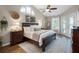 Bedroom with a large window, French doors, and elegant decor, creating a bright and inviting space at 174 Promenade Cir, Lake Mary, FL 32746