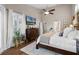 Bedroom with an attached bathroom, large windows, high ceilings, and wood floors creating a luxurious space at 174 Promenade Cir, Lake Mary, FL 32746