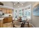 Cozy breakfast nook featuring a round table, shuttered windows, and natural light at 174 Promenade Cir, Lake Mary, FL 32746