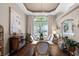 Elegant dining room featuring a long table, stylish chairs, and large windows at 174 Promenade Cir, Lake Mary, FL 32746