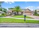 Beautiful home with lush green lawn and a brick driveway leads up to a charming residence with meticulous landscaping at 174 Promenade Cir, Lake Mary, FL 32746