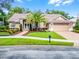 Charming home with a tile roof, manicured landscaping, and a brick driveway offers excellent curb appeal at 174 Promenade Cir, Lake Mary, FL 32746