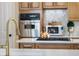 Close-up on modern fixtures, stainless steel appliances, and quartz countertops at 174 Promenade Cir, Lake Mary, FL 32746