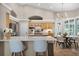 Open-concept kitchen featuring stainless steel appliances, an island, and a breakfast nook at 174 Promenade Cir, Lake Mary, FL 32746