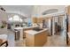 Open concept kitchen with stainless appliances, island cooktop, and views to the living area at 174 Promenade Cir, Lake Mary, FL 32746