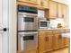 Updated kitchen features stainless steel appliances, double oven and natural wood cabinetry at 174 Promenade Cir, Lake Mary, FL 32746