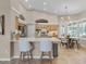 Bright and airy kitchen with a large island, modern lighting, and adjacent dining area at 174 Promenade Cir, Lake Mary, FL 32746