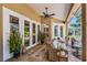 Covered lanai with brick pavers, a ceiling fan, and comfortable seating, ideal for relaxation at 174 Promenade Cir, Lake Mary, FL 32746