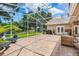 Screened-in lanai with brick pavers, exterior lighting, and comfortable seating, perfect for relaxing at 174 Promenade Cir, Lake Mary, FL 32746