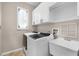 Laundry room featuring new appliances, white cabinets and a sink, for efficient chores at 174 Promenade Cir, Lake Mary, FL 32746