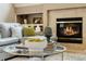 Close up of the coffee table with fireplace and comfortable seating in the background at 174 Promenade Cir, Lake Mary, FL 32746