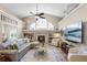 Bright living room featuring a fireplace, vaulted ceilings, and comfortable seating at 174 Promenade Cir, Lake Mary, FL 32746